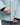 Hands adjusting main zipper on light blue Mammut women's jacket revealing inner cuff detail
