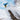Blue purple abstract camo Burton snowboard mid-air trick on powder jump