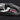 Close-up of Trigger System mechanism on black Leki ski glove showing red and white embroidery