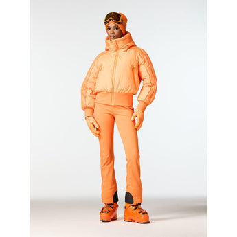 Woman modeling Goldbergh Volare W orange hooded ski jacket with side pockets and vertical seams