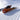 Snowboarder carving turn on Jones Freecarver 9000S orange zebra pattern board