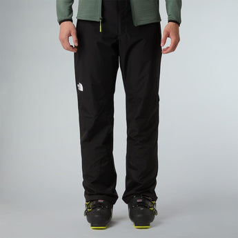 Men wearing The North Face Descendit black ski pants with green jacket and boots