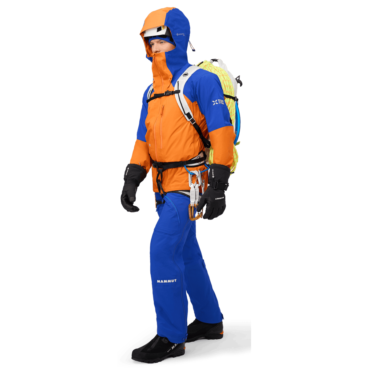Alpine climber wearing Mammut Eiger Nordwand Pro HS ski pants with harness and ropes