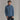 Blue reversible midlayer jacket on model hands in pockets
