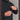 Man unzipping vertical chest pocket on black jacket