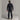 Black men's midlayer jacket with high collar worn over ski pants for winter sports
