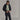 Front view of black Ortler Metawool jacket layered over t-shirt, highlighting relaxed fit