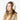 Side view of woman in cream Barts faux fur earmuffs and shearling coat
