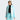 Woman wearing light blue gray white color-block ski jacket side view base layer