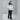Man wearing white and black Dot Out Pluma hooded puffer jacket with ski pants in studio