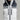 Men's white and black Dot Out Pluma puffer jacket front detail with quilted body and zippered pockets