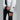 Side detail of white Dot Out puffer jacket sleeve with U logo patch and ribbed cuffs