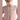 Close-up high collar and embroidered bird logo on light pink Arc'teryx jacket