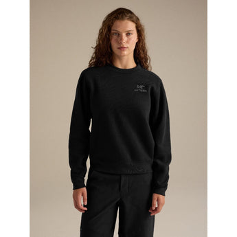 Woman wearing black Arcteryx Emblem Fleece Crew W with relaxed fit and embroidered logo